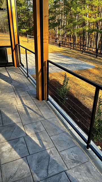 Black metal guardrail panels along a covered porch
