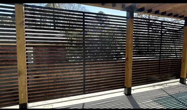 Horizontal metal architectural screen beside a property