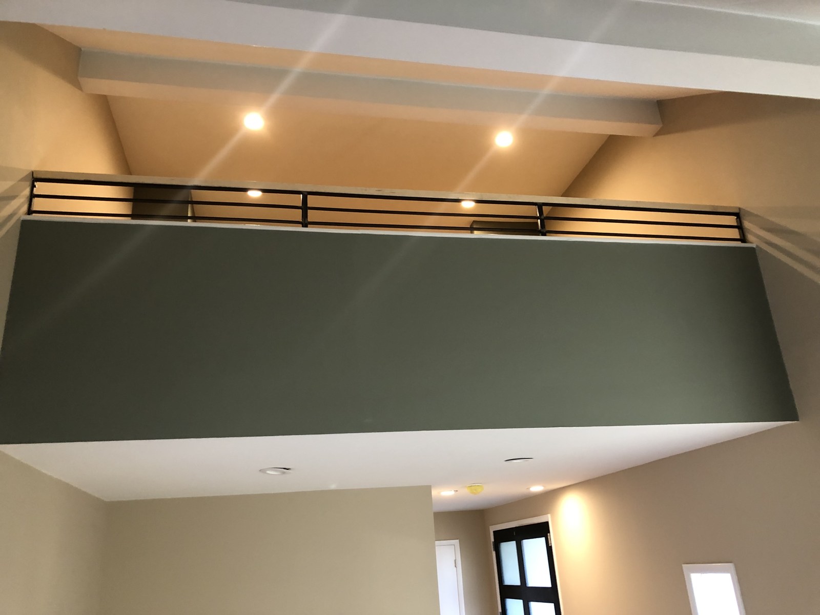 Wide interior view of a dark metal partition and railing