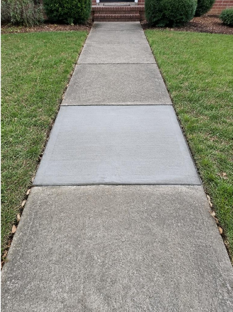 The same sidewalk with a level replacement panel after repair